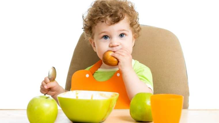 Criança comendo frutas: dê à alimentação a importância que ela merece